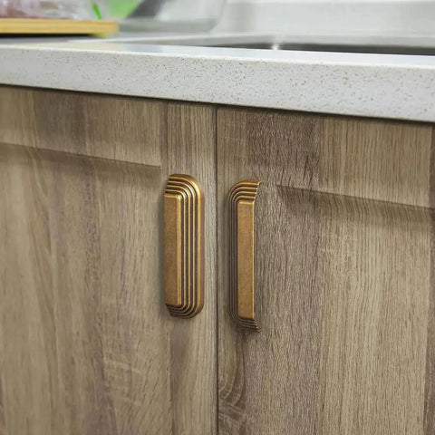 Six Pack 5 Inch Antique Brass Cup Pulls With Distinctive Layered Ribbed Multi Sectioned Design For Classic Cabinets And Drawers installed