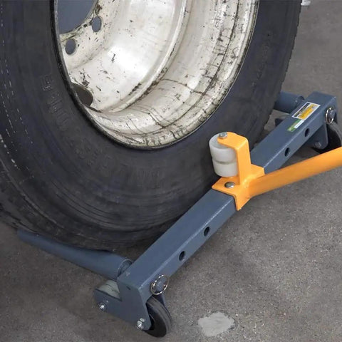 Rolling wheel dolly with blue steel frame and orange clamp supporting a large tire