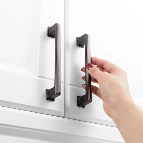 Hand using 10 Pack 5 Inch Cabinet Pulls In Oil Rubbed Bronze For Kitchen Cabinets Cupboards Dresser Drawers Bedroom Wardrobes And Bathroom Furniture Hardware Solid Metal Handles With Smooth Rounded Edges For Easy Use And Elegant Finish.