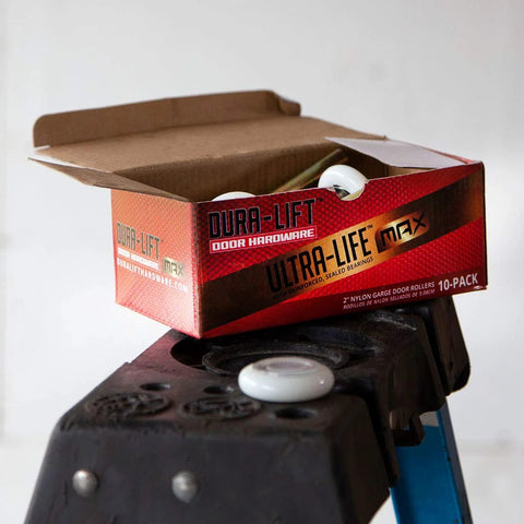 Open box of 2 Inch Sealed Nylon Garage Door Roller With 6200ZZ Bearing Quiet Operation Pack Of 10 on ladder