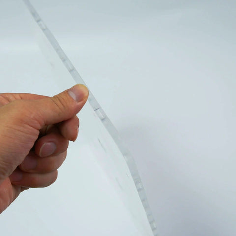 Side view of one quarter inch thick Transparent Acrylic Dog Hole Router Template Jig for woodworking, held by a hand.