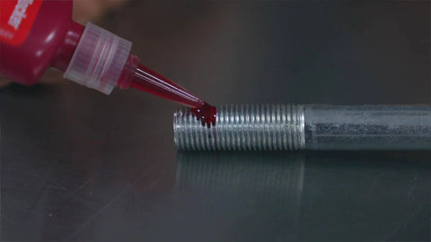 Applying Red High Temp Thread Locker For Engine Bolts 0.375 To 1 Inch Up To 450 Fahrenheit on metal bolt surface
