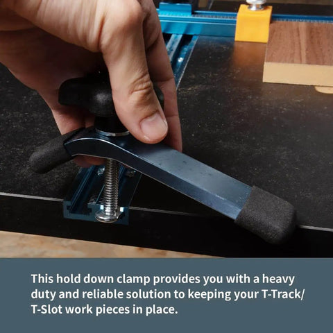 Hand adjusting Beefy T Track Hold Down Clamp Set For Woodworking Two Pack Five And One Half Inch Long By One And One Eighth Inch Wide Blue Black Finish on T-slot table.