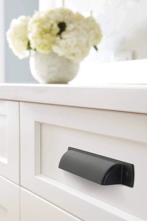 Rochdale Matte Black Cup Pull 3-3/4 Inch Center To Center Pack Of 10 Durable Zinc Cabinet Drawer Pulls installed on white drawer