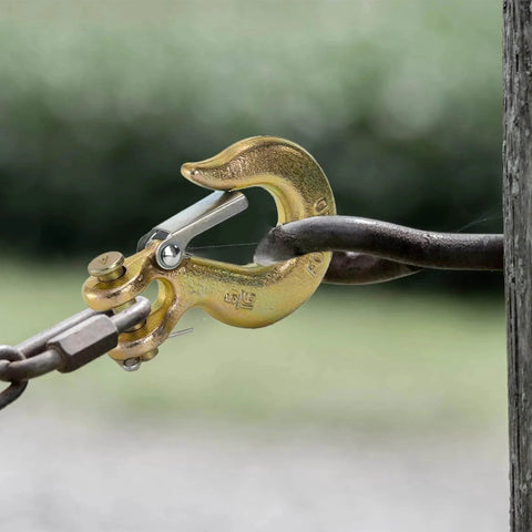 Close-up of a Five Sixteenth Inch Clevis Slip Hook with Latch, Forged G70 Steel, used with chain, for truck and trailer winch, yellow zinc finish.
