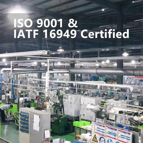 Industrial manufacturing facility with ISO 9001 and IATF 16949 certification signage displayed, showcasing machinery and operations.