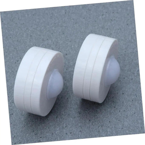 Close-up of two round lights from Six Pack LED Cabinet Lights Set With Dimmable Warm White Under Cabinet Lighting For Cupboards Kitchen And Office Use Touch Control Dimmer And Easy Install For Adjustable Brightness.