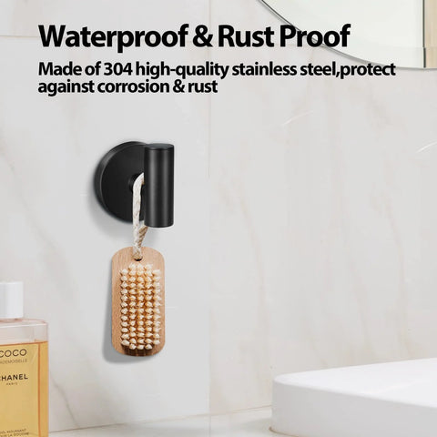 Two Pack Stainless Steel Black Matte Towel Hooks For Wall Mount And Door Hanger, holding brush in bathroom setting