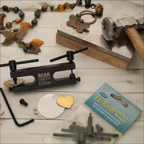EZ Rivet Piercing And Flaring Kit Maker Friendly With Three Thirty Second Inch T Bar Screws And Flat And Domed Bases on table