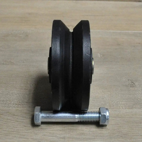 4 Inch V Groove Cast Iron Wheel Caster for Rolling and Sliding Gates includes axle bolt and nut, side view on wooden surface.