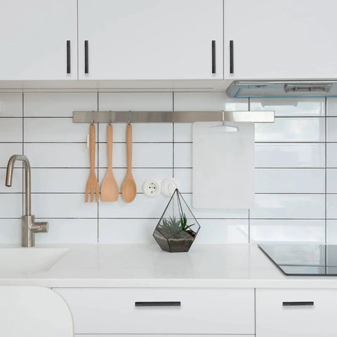 White kitchen with 10 Pack 5 Inch Matte Black Kitchen Cabinet Handles Knurled Cabinet Pulls visible on cabinets and drawers.