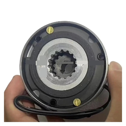 Electromagnetic brake unit front view; round black housing with silver center and splined shaft, cable visible