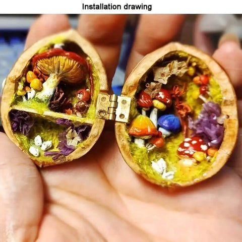 Open walnut shell showing small mushrooms and flora, connected by a hinge, resembling a tiny woodland scene.