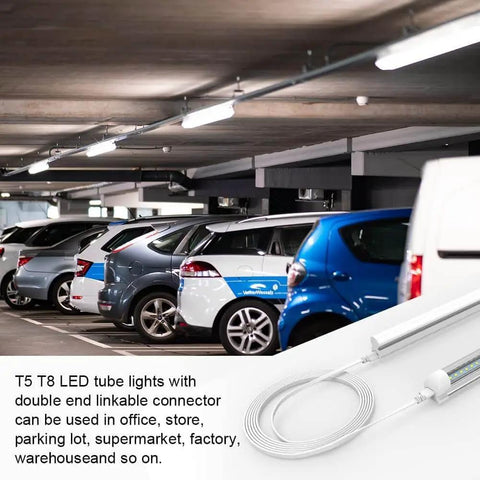 Four Pack 6 Foot T5 T8 LED Shop Light Connecting Wires Dual Ended Linkable Cables For LED Tube Fixtures No Soldering Required Plug And Play 3 Pin Connectors For Ceiling Lamps in a parking garage setting.