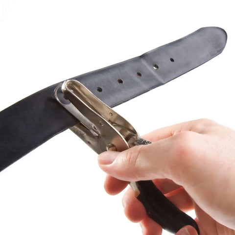One Quarter Inch Hole Punch Handheld With Soft Grip Ergonomic Handle for DIY Crafts Scrapbooking punching holes in a black belt.
