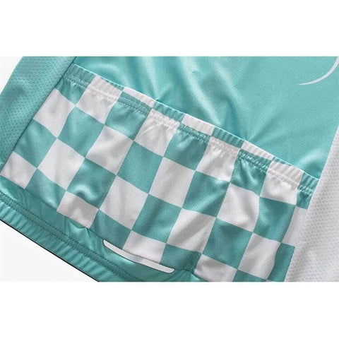 Close-up of teal and white checkered fabric design on a garment showing pockets and stitching details