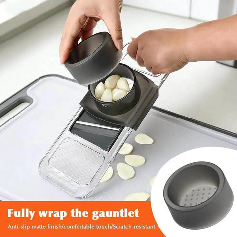 Six In One Mandoline Slicer With Adjustable Blades And Safe Hand Guard slicing garlic on a kitchen surface