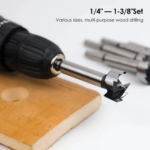 Close-up of an Eight Piece Forstner Bit Set for woodworking with center positioning, mounted in a drill, sizes 1/4 to 1-3/8 inch.