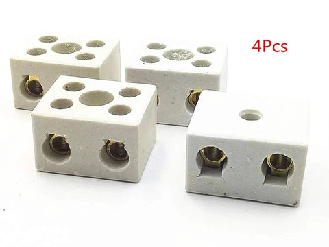 Four white porcelain ceramic terminal blocks with brass screw terminals and top wiring holes