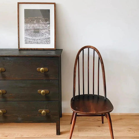 Dark wooden dresser with Retro Antique Brass Zinc Alloy Cabinet Knob With Backplate beside a wooden chair and framed artwork