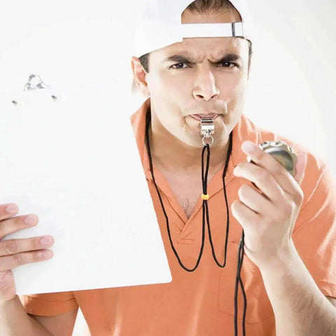 A person using a stainless steel whistle from the 2 Pack Stainless Steel Sports Whistles With Lanyards For Coaches Referees And Officials Loud Crisp Sound Reaches Up To 120dB Perfect For Training Games Lifeguards And Field Officials.