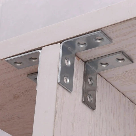 10 Pack Right Angle Corner Brackets For Furniture And Cabinets installed on wooden shelf, silver iron joint fasteners for heavy duty support.
