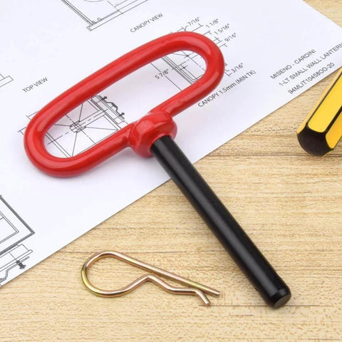 Two Pack Three Quarter Inch By Four And A Half Inch Steel Hitch Pins With Red Rubber Coated Handles And Clips For Tow Hitch Receiver Heavy Duty Clevis Pins Red Color Trailer Pins on a wooden surface.