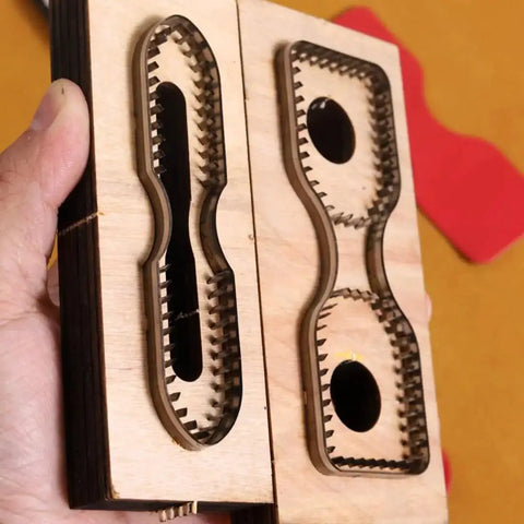 2 Piece Strap End Cutting Mold Set With Wooden Dies And Japanese Steel Cutters in hand, front view
