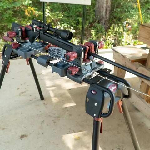 Deluxe Carbon Fiber Cleaning Rod For .27 to .45 Caliber Rifles displayed on gun maintenance stand outdoors.