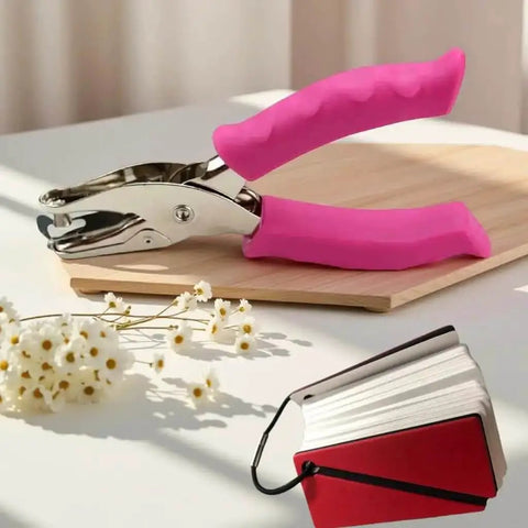 1/4 Inch Pink Handheld Circle Hole Punch For Crafting with flowers and card samples on table