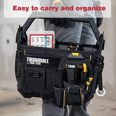 Person holding a Toughbuilt tool tote with multiple pockets and tools, showcasing a compact and organized design.
