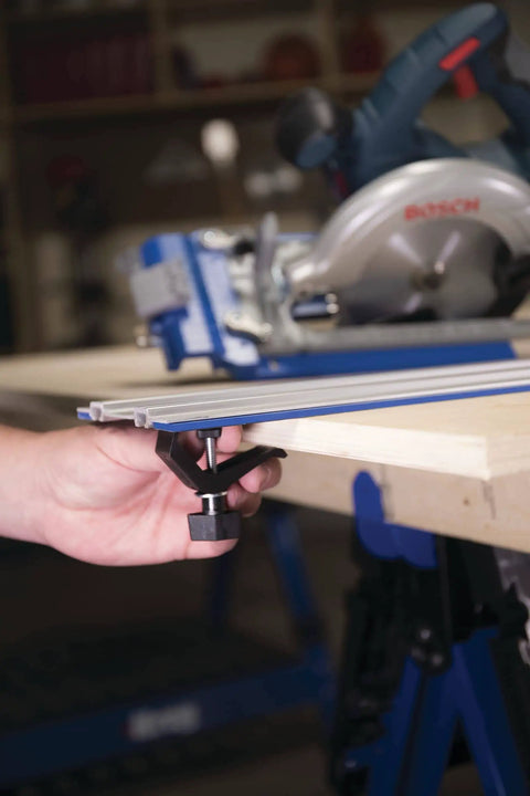 Person attaching Two Track Clamps With Non Slip Grip For Track Saws to a wooden piece for T Slot Tracks, Model KMA7520.