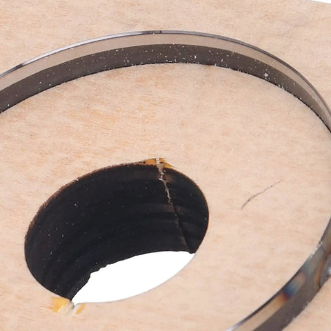 Close-up of 65mm Circular Cutting Die for Leather Cardboard Rubber Plastic Clay, Alloy Steel, on Birch Wood Base