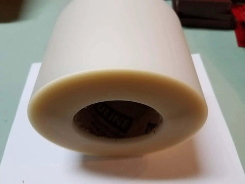 End view of 6 Inch Wide Urethane Die Protection Film Roll, 0.015 Inch Thick, 100 Foot Long For Press Brake Applications on table