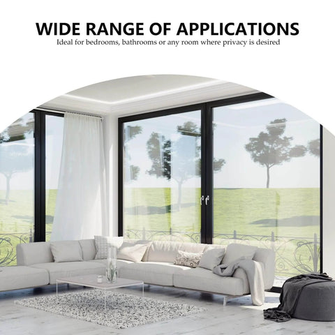 Modern living room with large windows, white sofa, and a wide view of green outdoor landscape; ideal for privacy solutions.