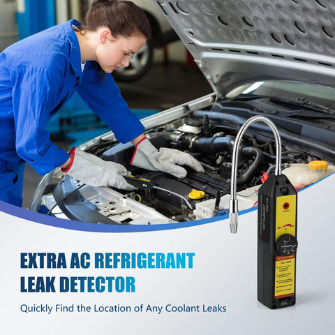 Handheld AC refrigerant leak detector with yellow panel and flexible probe in engine bay, technician in blue coveralls.