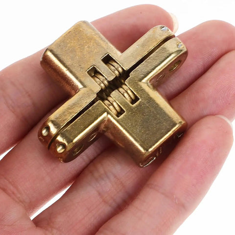 Hand holding Hidden Cross Hinge Set Four Pcs Alloy Invisible Cabinet Door Hinges 1.64 by 1.3 Inches Silent Concealed Mount