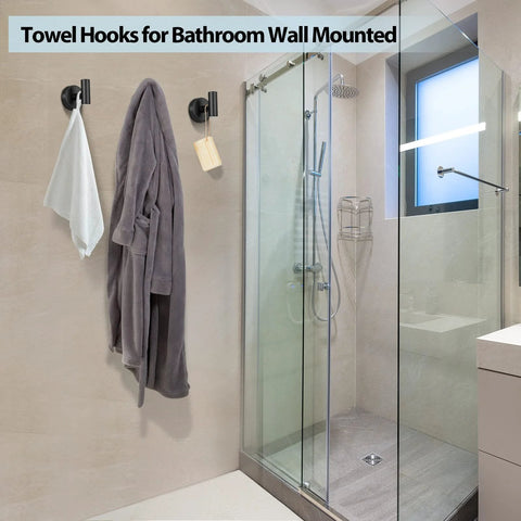 Bathroom showing two pack stainless steel black matte towel hooks for wall mount and door hanger, holding a robe and towel.
