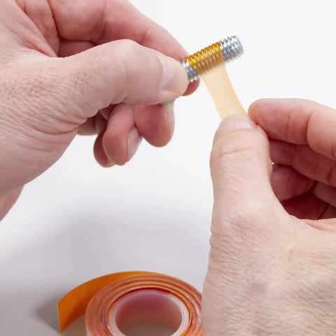 Hands applying VC-3 Threadmate Red Threadlocker And Tape Kit to fastener, preventing loosening, for internal external threads, 5mL tube.