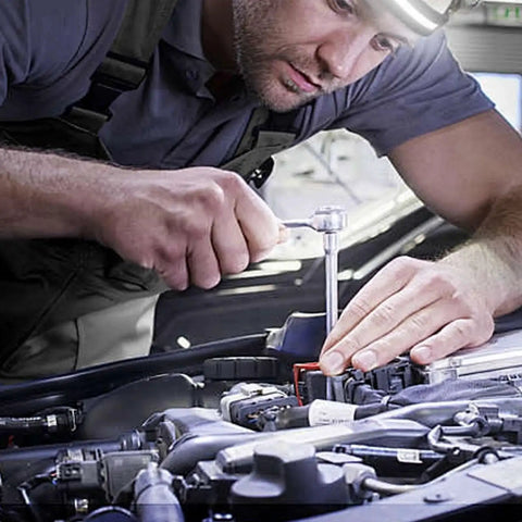 Close-up of mechanic using a 1/4–1/2 in drive converter sleeve set (alloy) on a car engine