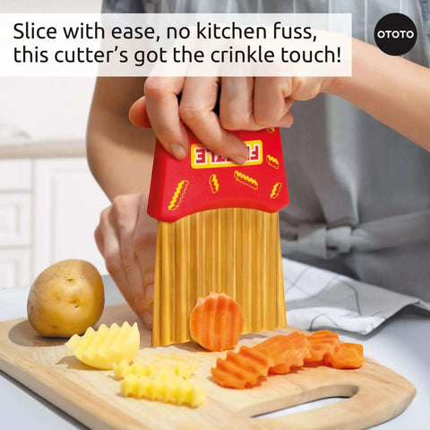 Hand using Frizzle Crinkle Fry Cutter to create waffle fries and veggie crinkles from potatoes on a kitchen counter OTOTO.
