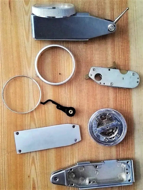 Disassembled components of Pro Grade Dial Test Indicator KHCRAFT 0 To 0.03 Inches Range With 0.0005 Inch Graduation.