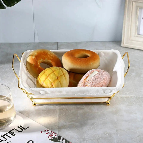 Gold Wire Serving Basket For Fruit And Bread with linen liner holding assorted breads on a kitchen counter