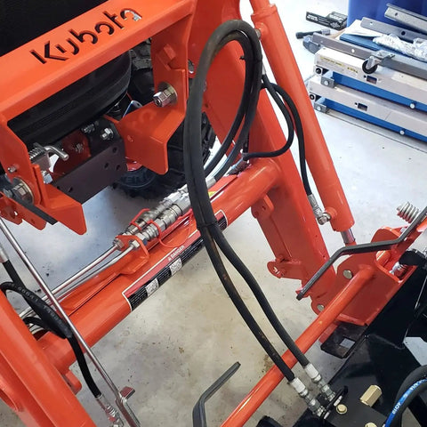 Close-up of Kubota skid steer with Flat Face Hydraulic Quick Disconnect Couplers Three Quarters Inch NPT With One Half Inch ISO 16028 Body.
