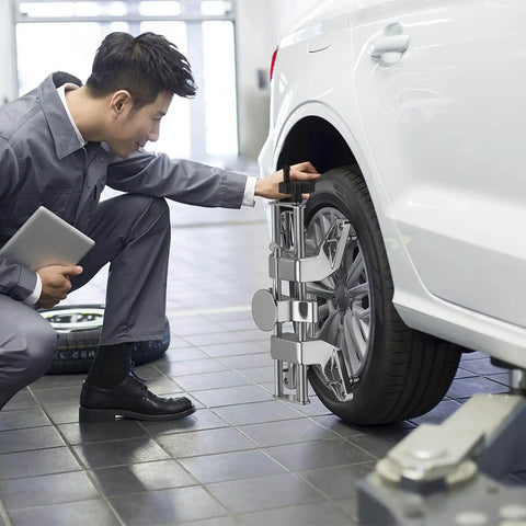 Mechanic using Beefy Wheel Alignment Clamp Tool With Magnetic Adapter For 12 To 25 Inch Rims Universal Clamp on car tire