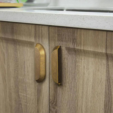 Six Pack 5 Inch Antique Brass Half Moon Cabinet Cup Handles For Kitchen Drawers And Cabinets installed on wooden cabinet.