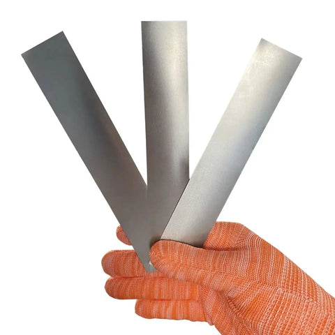 Gloved hand holding 3-piece 304 Stainless Steel Pro Grade Shim Stock Set 1 Inch Wide 6 Inches Long 0.001 0.0015 0.002 Inch Thickness