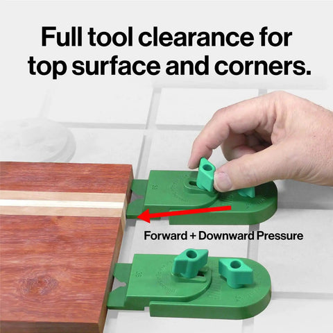 Hand using Matchfit Inline Dovetail Ramp Clamps for track system with low profile rotating heads on wooden board