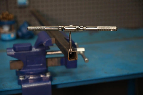 One Eighth To Twenty Seven NPT And Twenty One Sixty Four Combo Pipe Thread Tap installed in a vice for precise internal threads