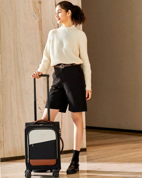 Woman standing with Airline Ready Luggage Set Rolling Suitcase LoveVOOK 5 Piece Carry On Luggage Set in indoor setting